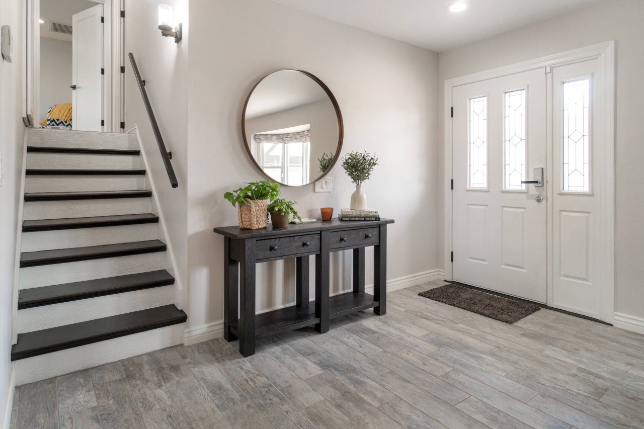 An entryway with a windowed door, a side table, and a mirror at Rico's Window Coverings & Films near Sacramento, California